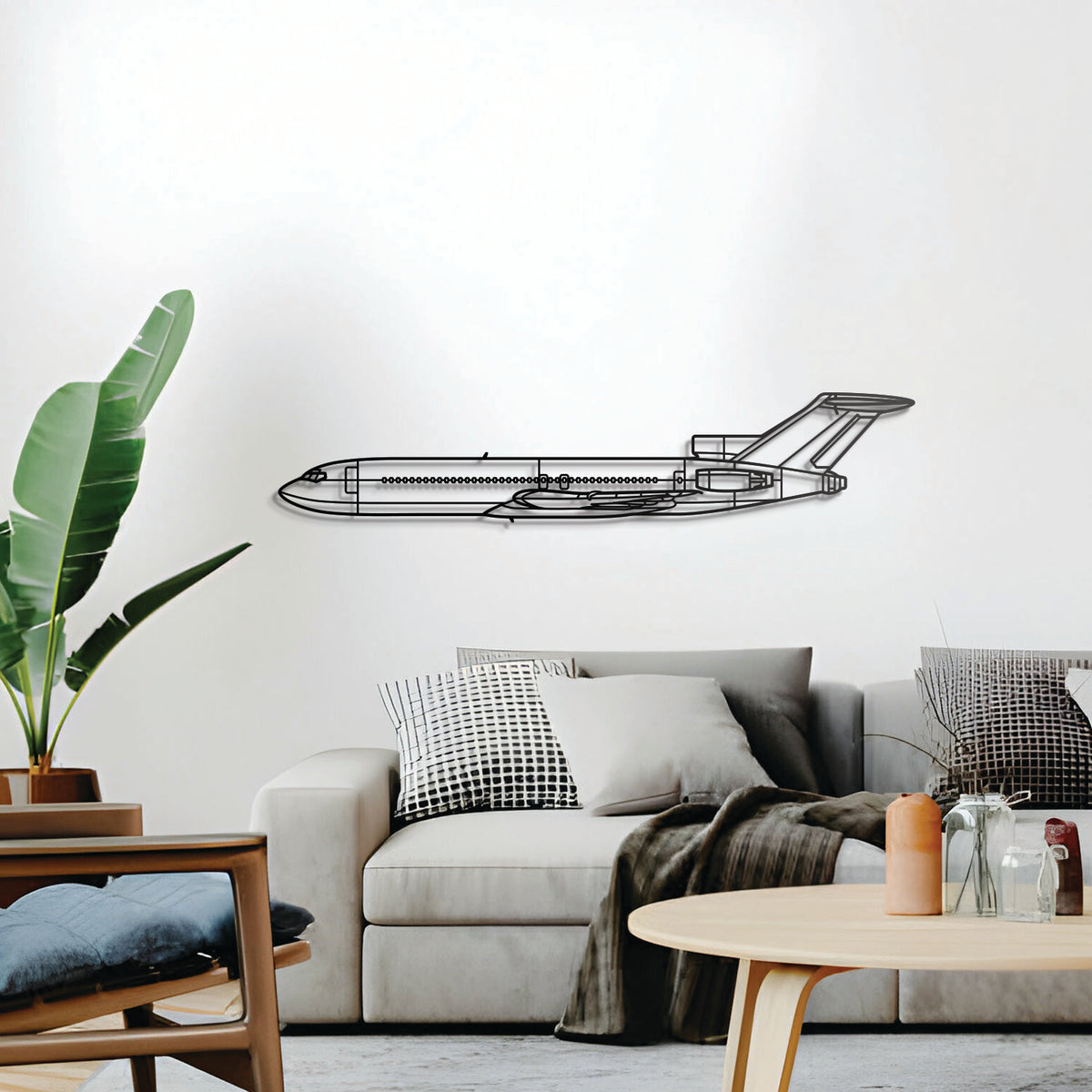 Minimalist Boeing 727 metal silhouette — gently elevated from the wall for depth